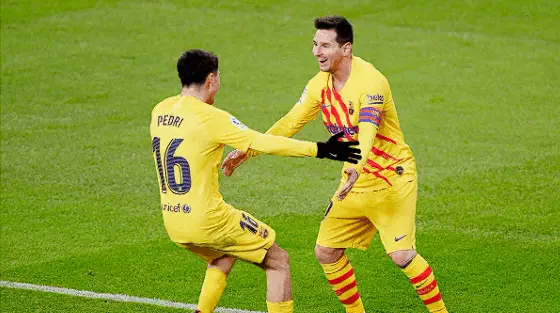 Pedri celebrates with Messi.